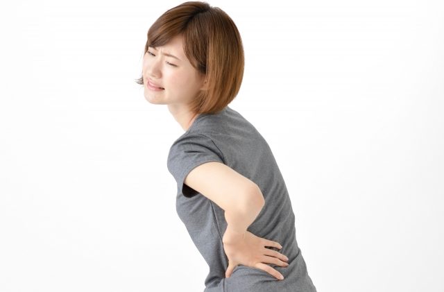 腰痛に悩む女性の写真